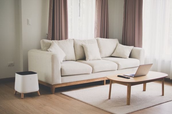 The Sqair with beautiful design next to a couch in a living room